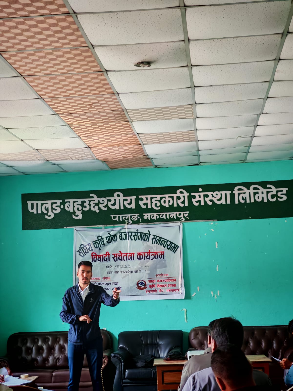 Team member addressing farmers during the safety briefing